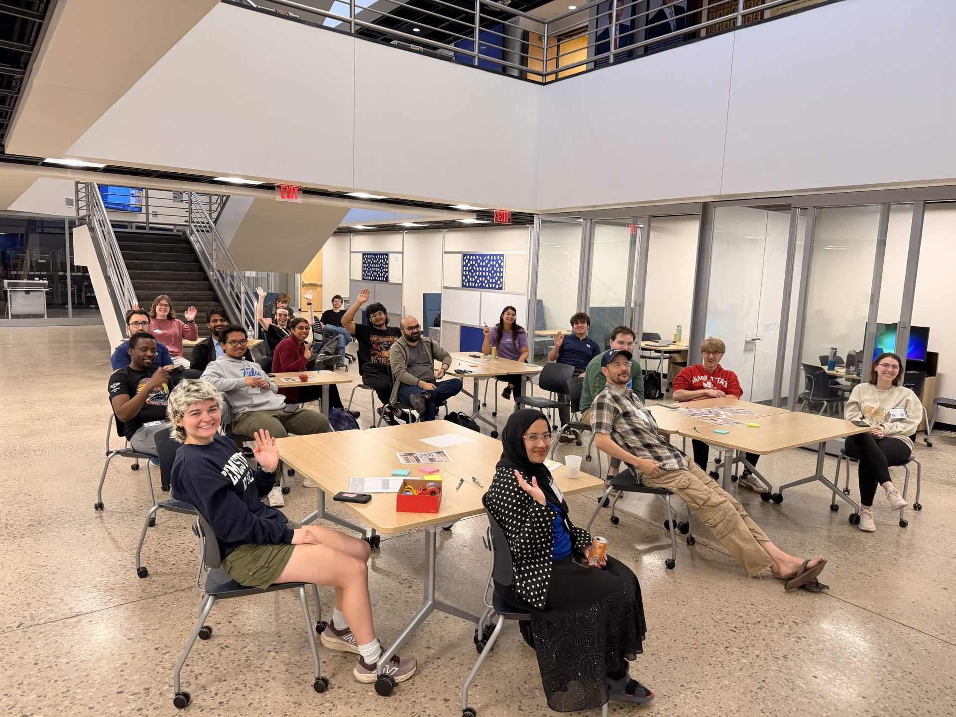 Hackathon attendees waving at the camera