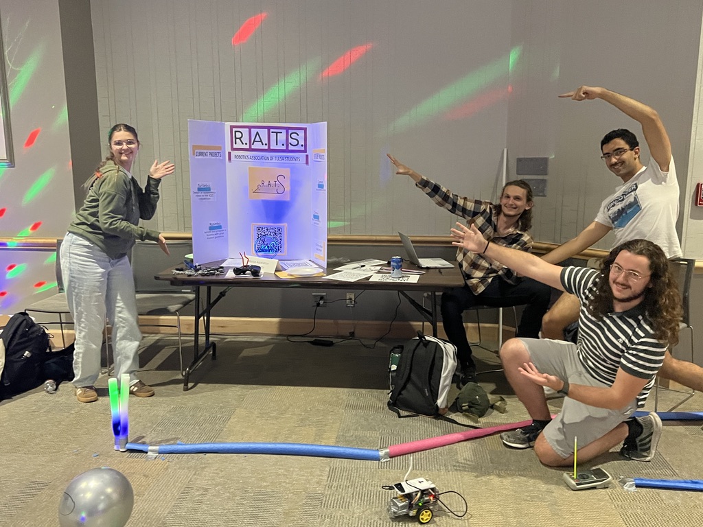 R.A.T.S. members posing by their RC robot race track made of pool noodles